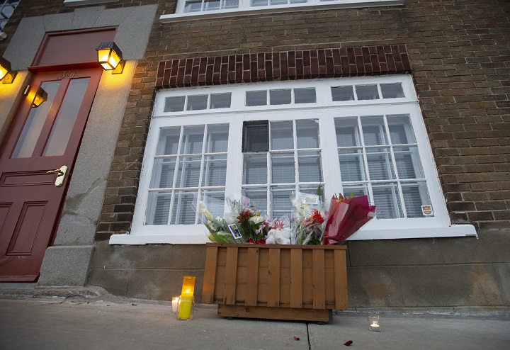 A box of flowers and candles sit in front of Suzanne Clermont's house in Quebec City, Sunday, Nov. 1, 2020. 