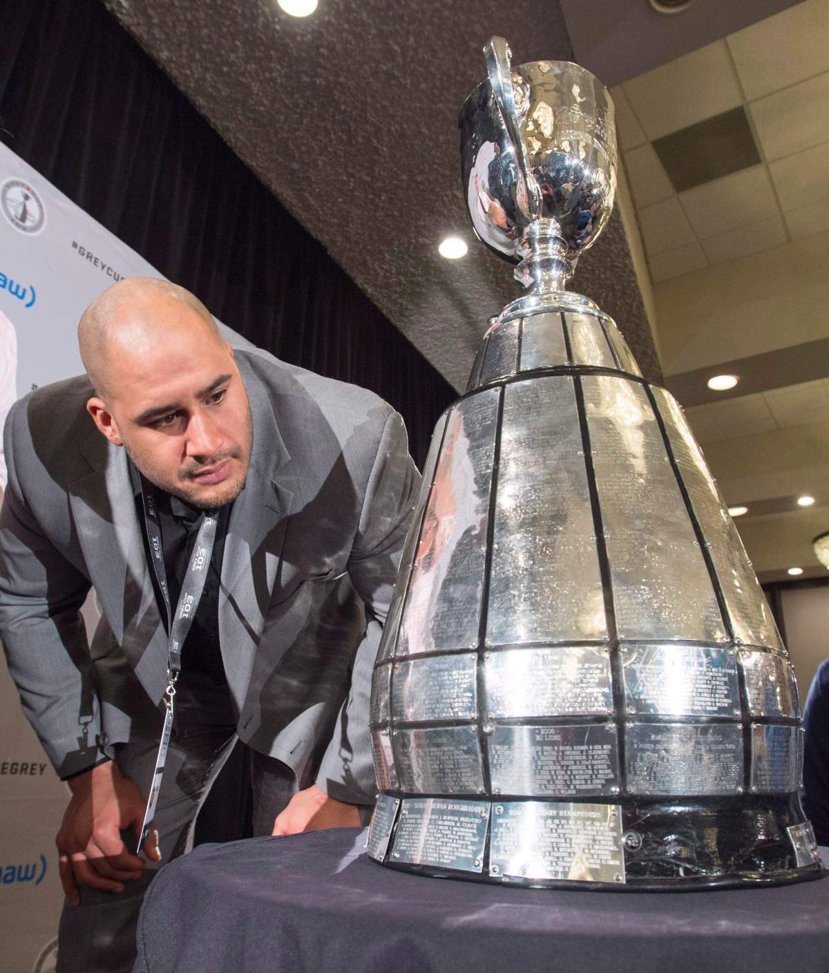 Edmonton defensive tackle Eddie Steele looks at the Grey Cup at the West Division media lunch Thursday, November 26, 2015 in Winnipeg.