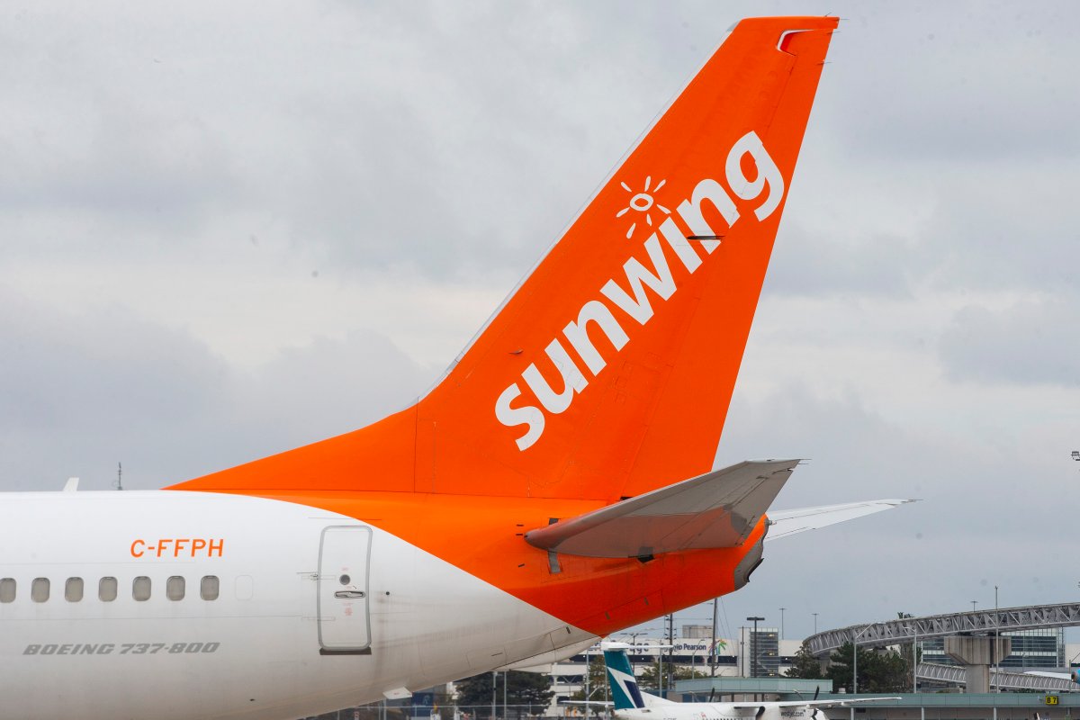 A Sunwing plane stands at a gate at Toronto's Pearson Airport.