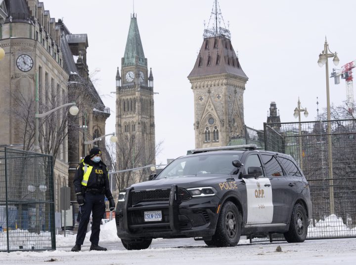 A police officer mans a checkpoint near Parliament Hill, Wednesday, Feb. 23, 2022 in Ottawa.  