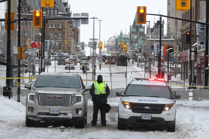 A police officer stands guard, as police work to evict the last of the trucks and protesters after a protest against coronavirus disease (COVID-19) vaccine mandate in Ottawa, Ontario, Canada,Ottawa, Ontario, Canada, February 20, 2022. 