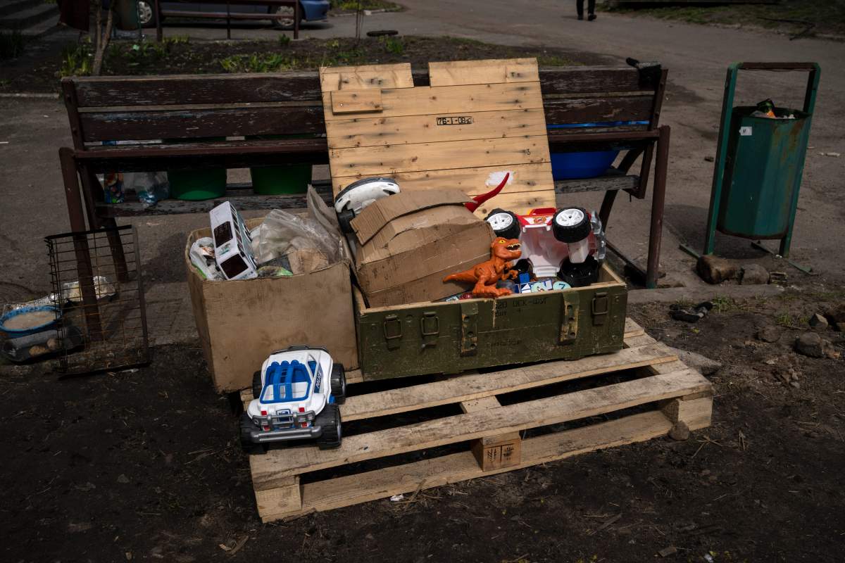 Children’s toys are stored inside a box of military ammunition in Bucha, on the outskirts of Kyiv, Ukraine, Friday, April 8, 2022. (AP Photo/Rodrigo Abd)