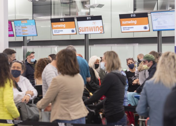 Travellers wait in line at a Sunwing Airlines check-in desk at Trudeau Airport in Montreal, Wednesday, April 20, 2022.