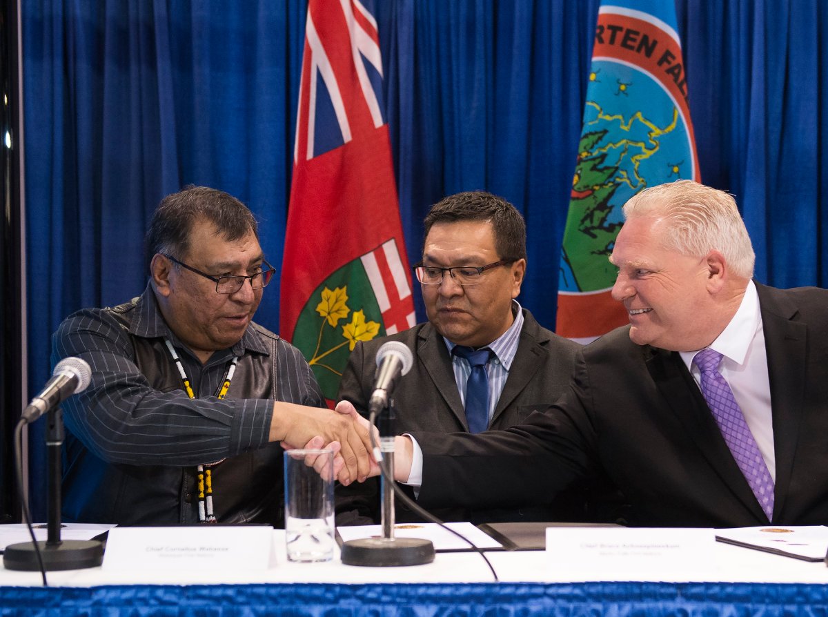 Ontario Premier Doug Ford shakes hands with Chief Cornelius, Wabasse Webequie First Nation, left, and Chief Bruce Achneepineskum, Marten Falls First Nation, centre, after signing a new deal in the ring of fire in Northern Ontario at the Prospectors and Developers Association of Canada's annual convention in Toronto on Monday, March 2, 2020. 
