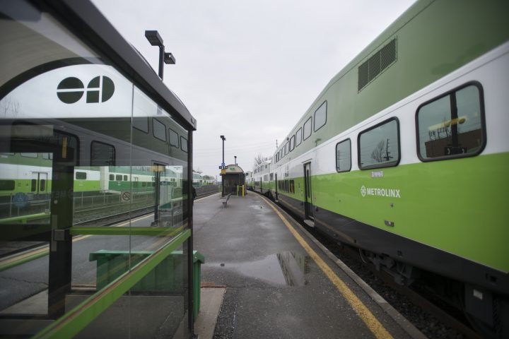 A GO train moves past cars parked in reserved spots at the Mimico GO station on Jan 14 2020.