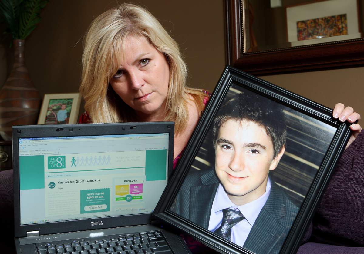 FILE PHOTO – Kim LeBlanc holds a photograph of her late son Tyler Schwering, 15, in Fergus, Ont., on Wednesday, June 13, 2012.