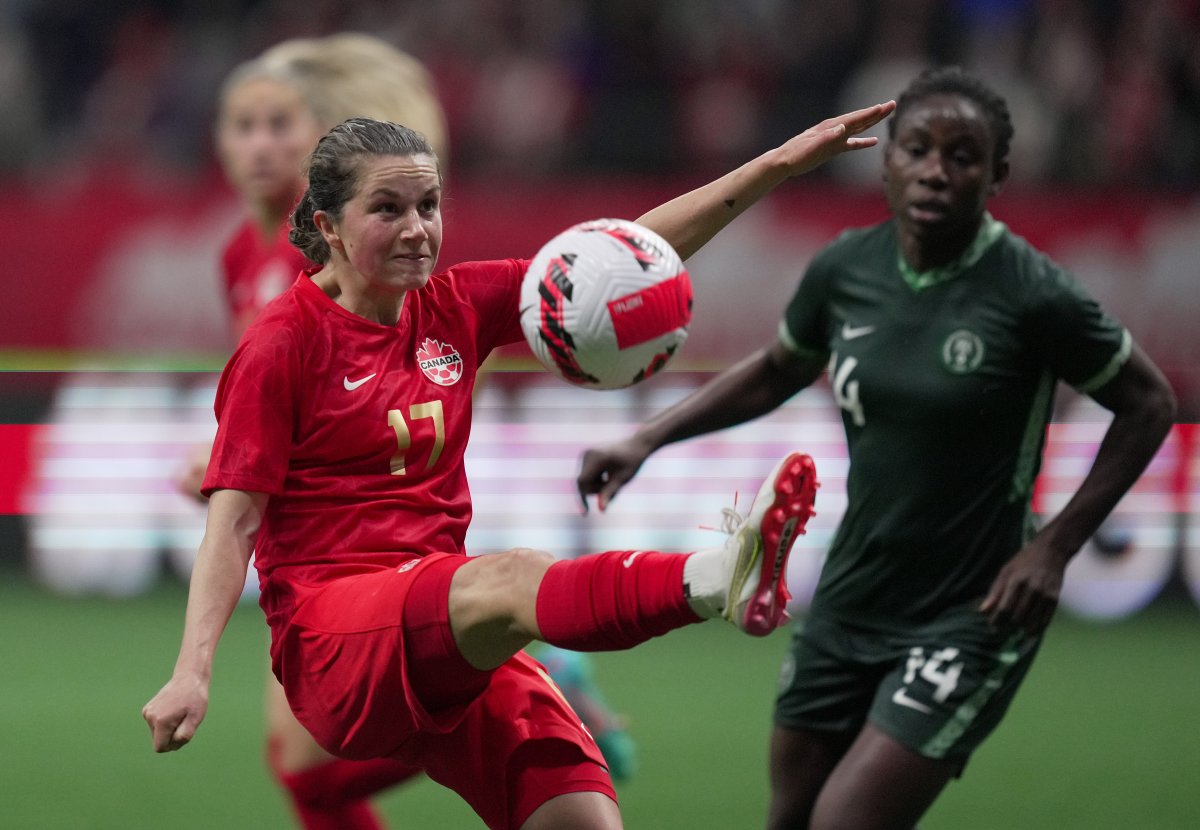 Canada’s Jessie Fleming, left, kicks the ball away from Nigeria’s Christy Ucheibe during the first half of a women’s friendly soccer match, in Vancouver on Friday, April 8, 2022. 