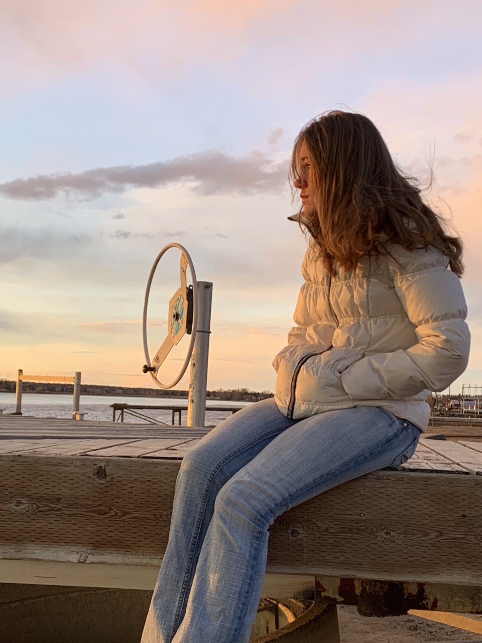 Long COVID patient Charlise Bruchet looks out on Chestermere Lake on April 4, 2022.