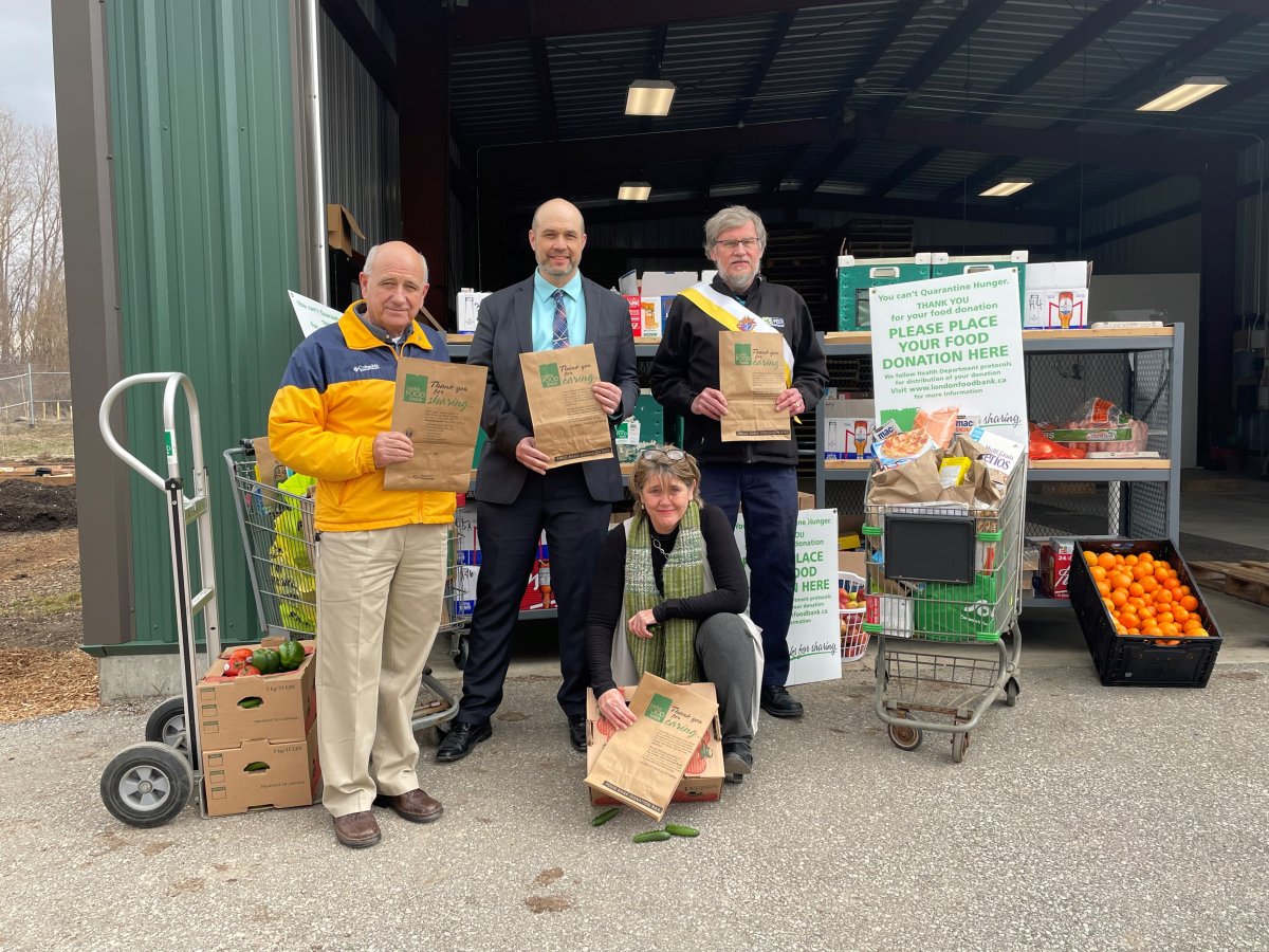 Glen Pearson, co-director of London Food Bank (left), David Billson, CEO and co-founder of rTraction (middle), Gary Masters, district deputy, Knights of Columbus (right), and Jane Roy, co-director of London Food Bank (front) at the Spring Food Drive Launch.