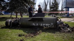 Ukrainian police inspect the remains of a large rocket with the words "for our children" in Russian next to the main building of a train station in Kramatorsk, eastern Ukraine, that was being used for civilian evacuations, that was hit by a rocket attack killing at least 35 people, on April 8, 2022.