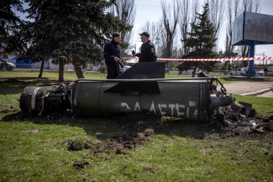 Ukrainian police inspect the remains of a large rocket with the words "for our children" in Russian next to the main building of a train station in Kramatorsk, eastern Ukraine, that was being used for civilian evacuations, that was hit by a rocket attack killing at least 35 people, on April 8, 2022.
