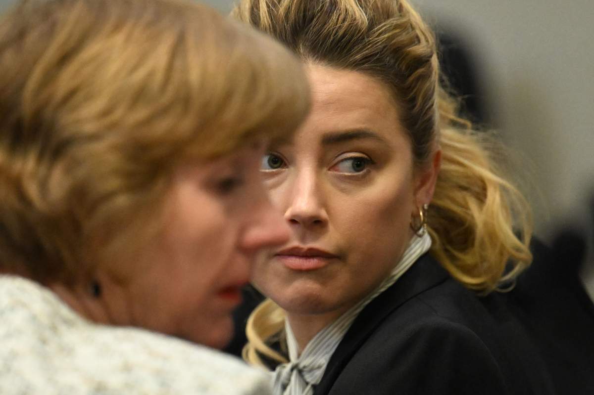 Attorney Elaine Bredehoft (L) and U.S. actress Amber Heard look on during a trial in the Fairfax County Circuit Courthouse in Fairfax, Virginia, on April 19, 2022. Johnny Depp is suing ex-wife Amber Heard for libel after she wrote an op-ed piece in The Washington Post in 2018 referring to herself as a public figure representing domestic abuse.
