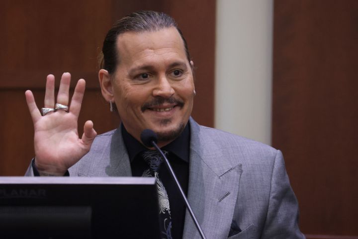 Johnny Depp displays the middle finger of his hand, injured while he and his ex-wife Amber Heard were in Australia in 2015, as he testifies during his defamation trial against Heard at the Fairfax County Circuit Courthouse in Fairfax, Va., April 20, 2022.