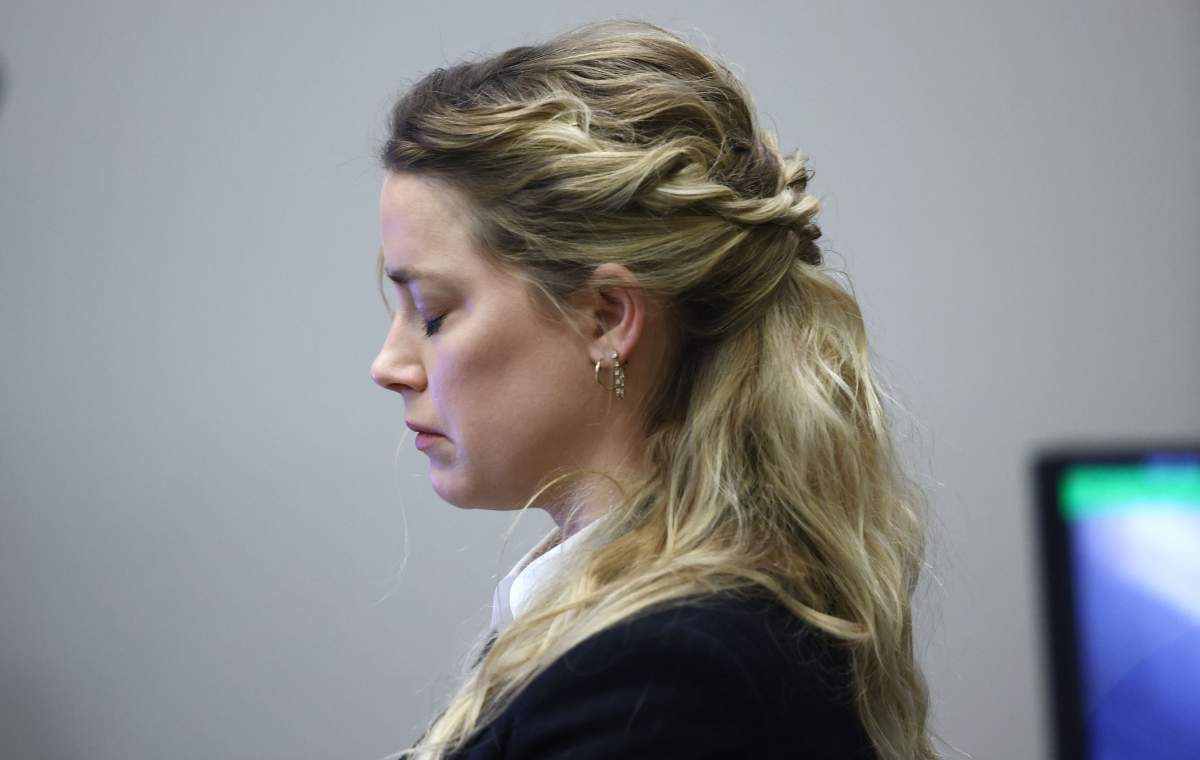 Amber Heard reacts as she listens to an audio recording of she and Johhny Depp arguing during the 50 million US dollar Depp vs Heard defamation trial at the Fairfax County Circuit Court in Fairfax, Virginia, April 21, 2022.