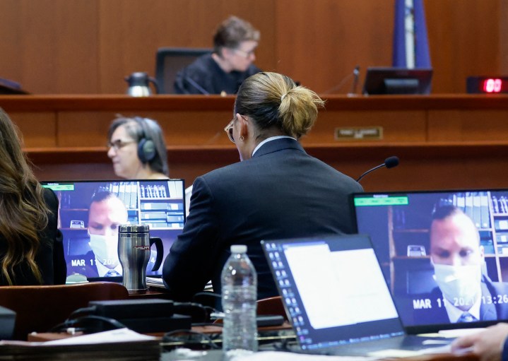 Actor Johnny Depp watches a deposition testimony of Los Angeles Police Department (LAPD) officer Tyler Hadden during Depp's defamation trial against his ex-wife Amber Heard, at the Fairfax County Circuit Courthouse in Fairfax, Va., on April 27, 2022.
