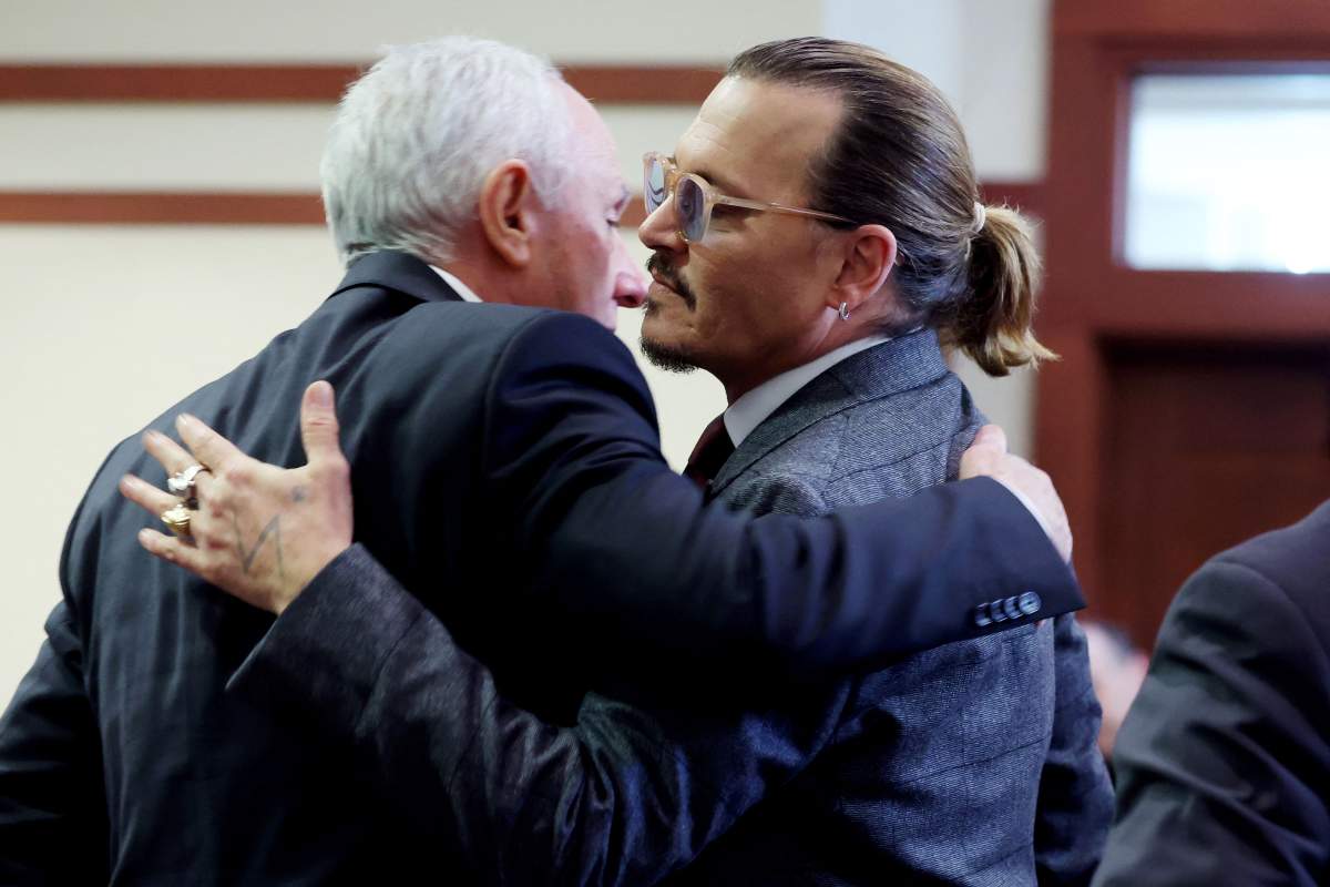 US actor Johnny Depp (R) embraces his business manager Edward White (L) as court finishes for the day during the 50 million US dollar Depp vs Heard defamation trial at the Fairfax County Circuit Court in Fairfax, Virginia, April 28, 2022.