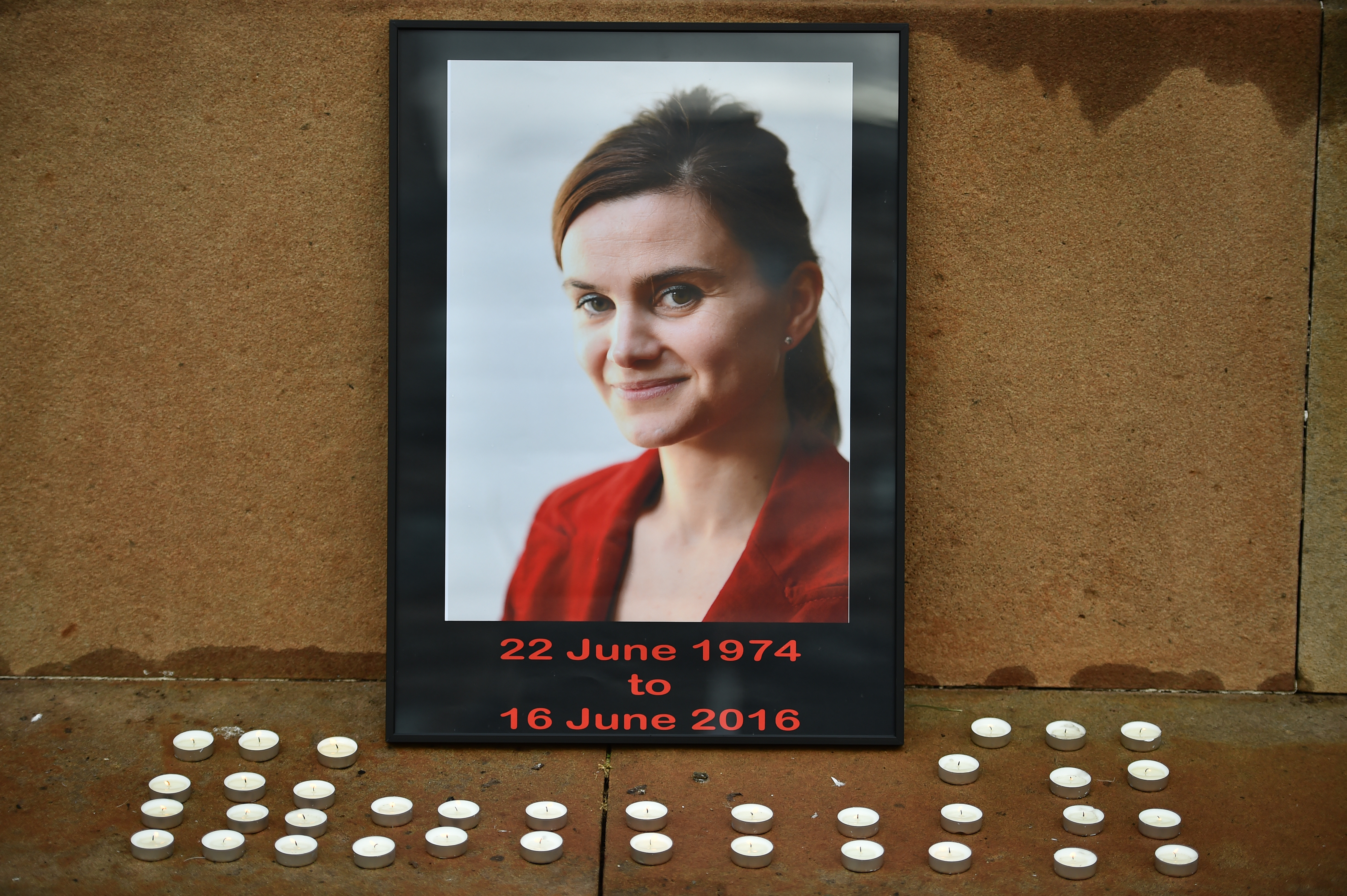 GLASGOW, SCOTLAND – JUNE 17, 2016: Candles surround a photo of Labour MP Jo Cox. (Photo by Jeff J Mitchell/Getty Images)