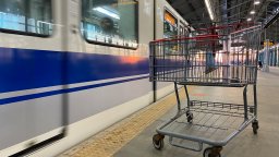 An empty shopping cart beside the LRT