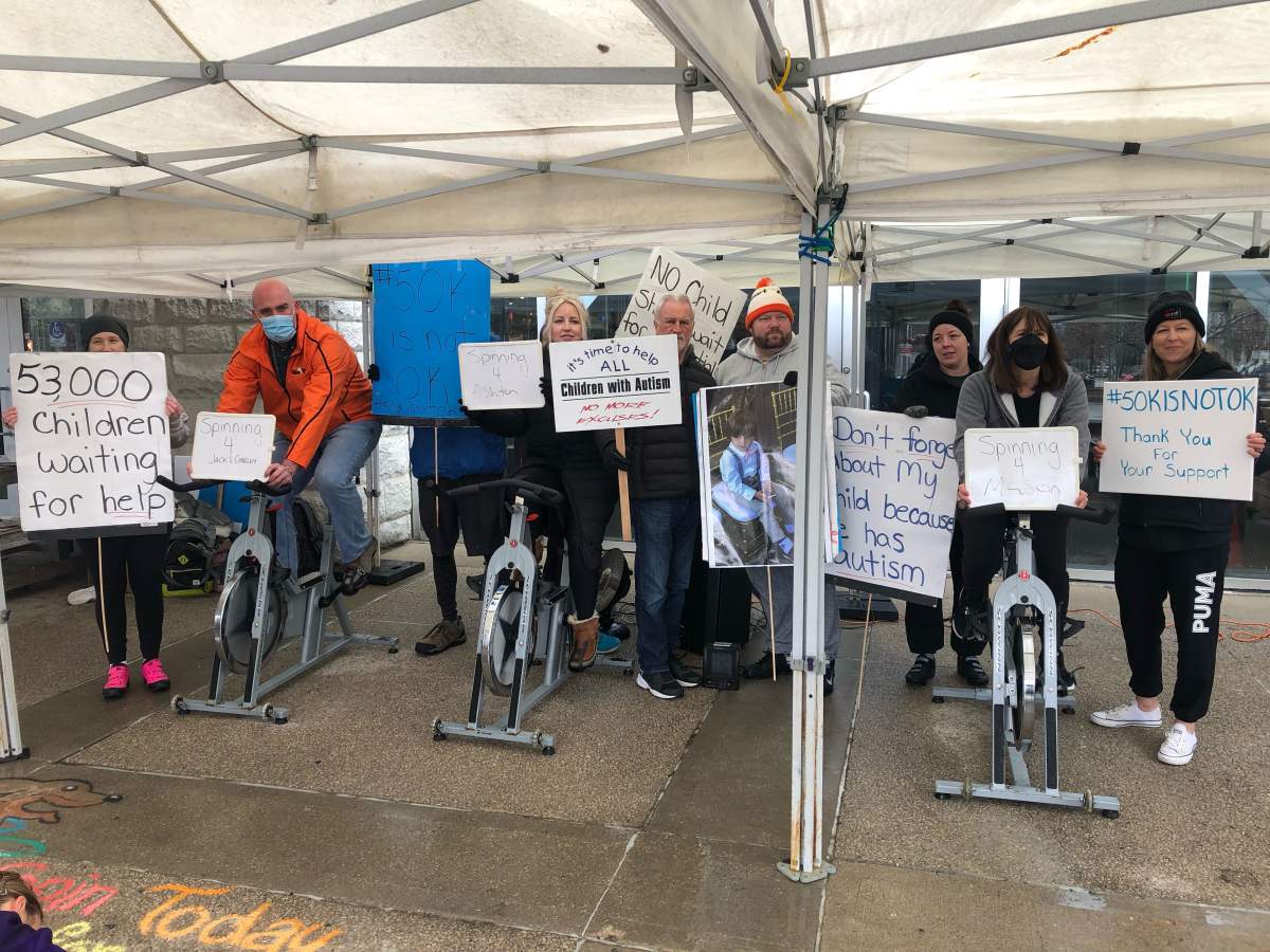 Members of the Ontario Autism Coalition are joined by local NDP MPPs during Friday's event at Covent Garden Market in London, Ont.
