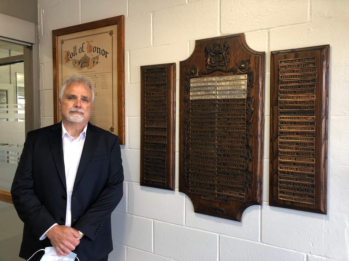 London, Ont., resident Mike Lee stands next to the set of memorial plaques that he helped find a permanent home for.