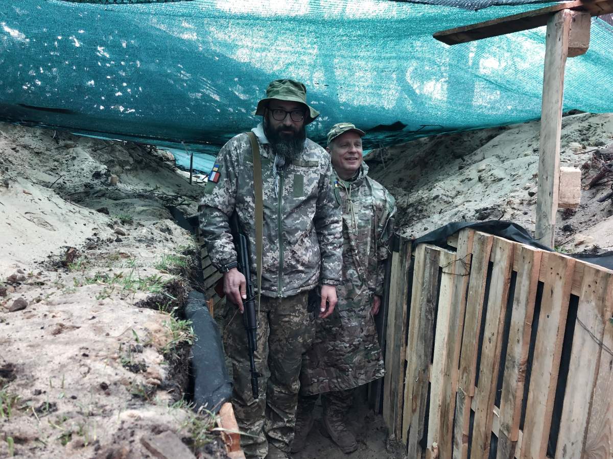 Territorial Defence Force member and commander Alexander Tolinov, right, in his trenches, April 1, 2022.