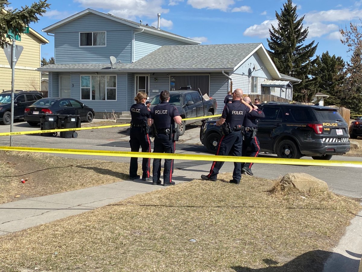 Calgary police stand near Radcliffe Close S.E. on April 1, 2022, following reports of gunshots, investigating a suspicious death.