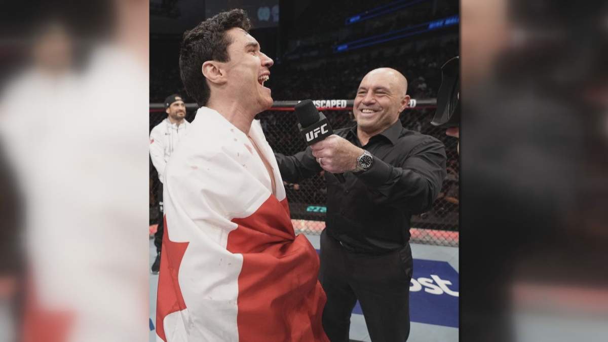 Mike Malott celebrating his win at UFC 273 with commentator Joe Rogan.
