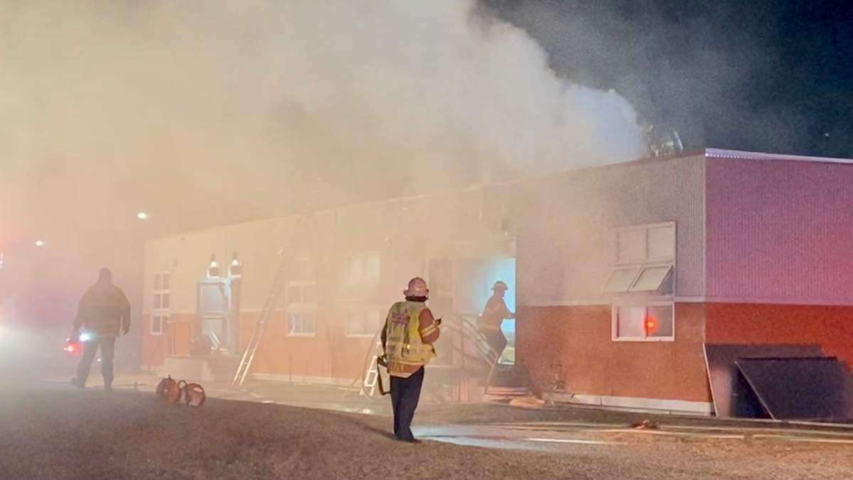 Edmonton firefighters battle a blaze at T.D. Baker School Thursday, April 14, 2022.