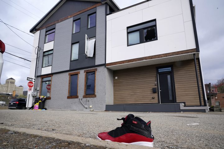 A lone sneaker lies near a short-term rental property where police say a shooting took place in Pittsburgh early Sunday morning, April 17, 2022. 