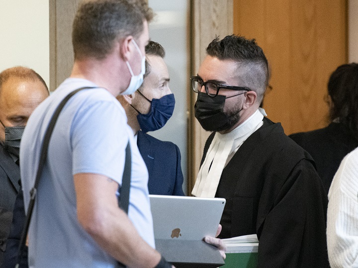 Defence lawyer Benoit Labrecque, right,  walks out of a courtroom, Thursday, November 5, 2020  in Quebec City. Labrecque is representing Carl Girouard,  the man charged in connection with the Halloween night sword attack in Quebec City that left two dead and five injured. 
