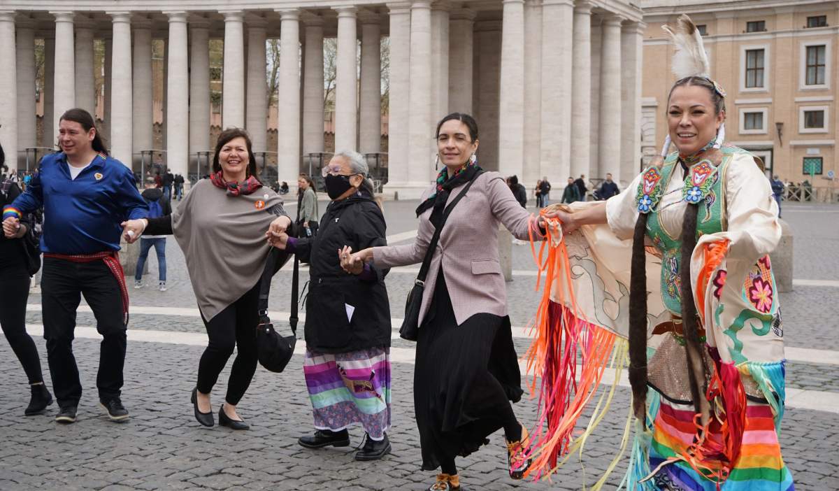Indigenous delegates, including Tk'emlúps te Secwe̓pemc's Kúkpi7 Rosanne Casimir, dance around the Vatican Obelisk on April 1, 2022.