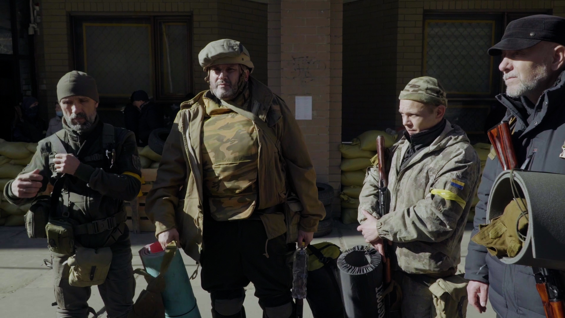 Ruslan instructs his fellow soldiers on how to survive a Grad missile attack.