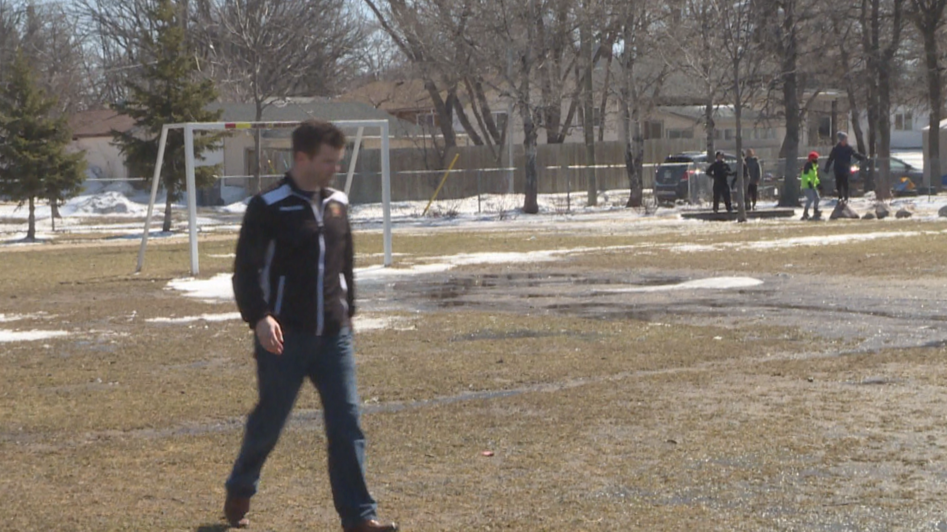 Scott Dixon, the Winnipeg Youth Soccer Association’s executive director, inspecting the field conditions on the south side of the city Monday morning.