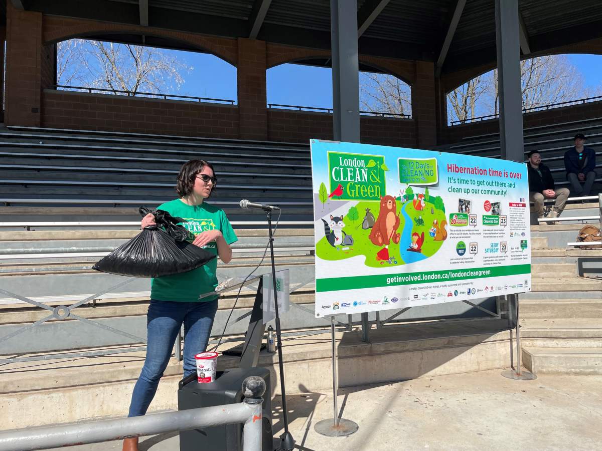 Skylar Franke holding 3000 cigarette butts collected at Western University and Gibbons Park.