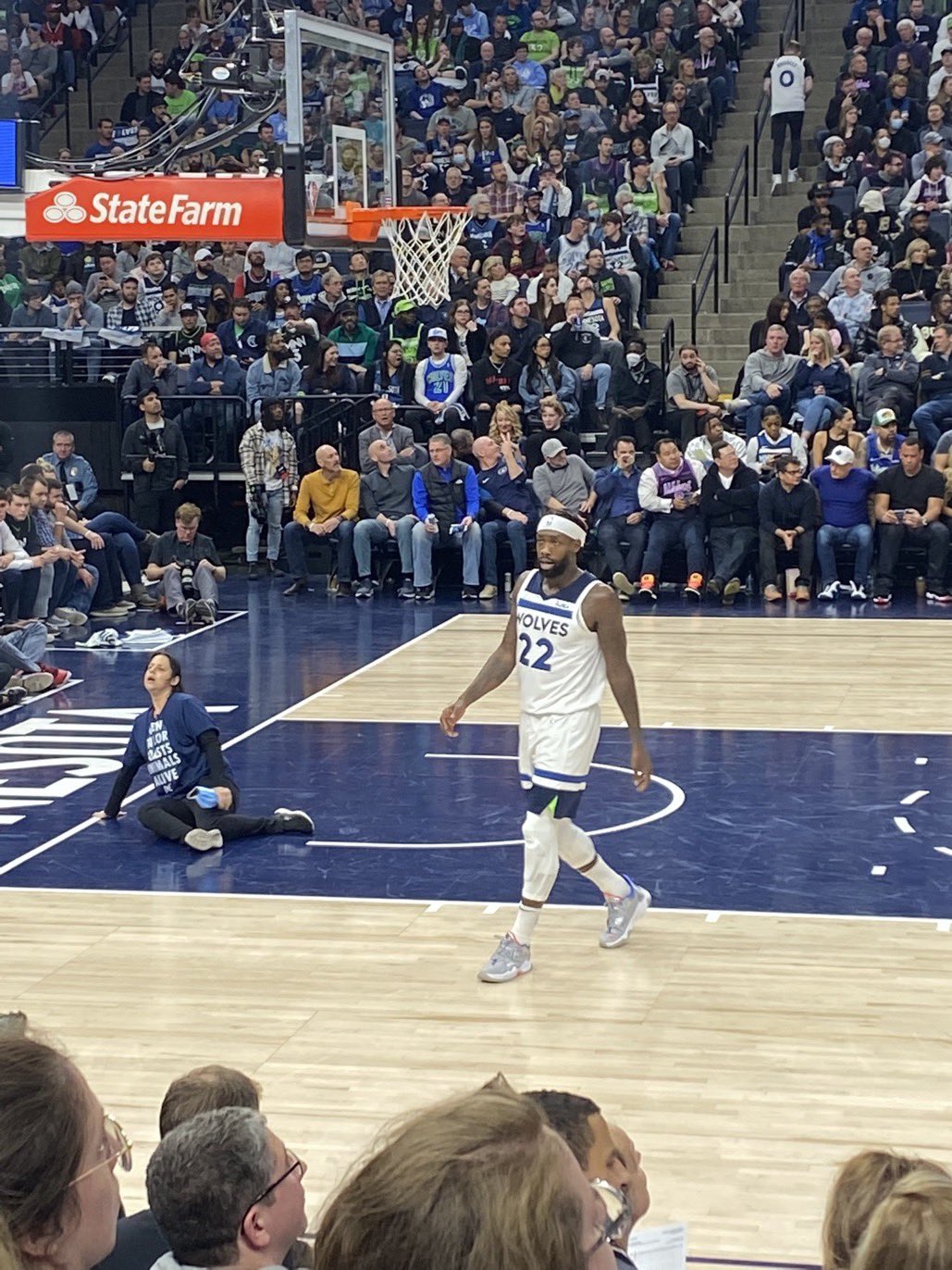 Alicia Santurio, a.k.a. "Glue Girl" is seen in this photo with her hand glued to the floor of the basketball court in Minneapolis.
