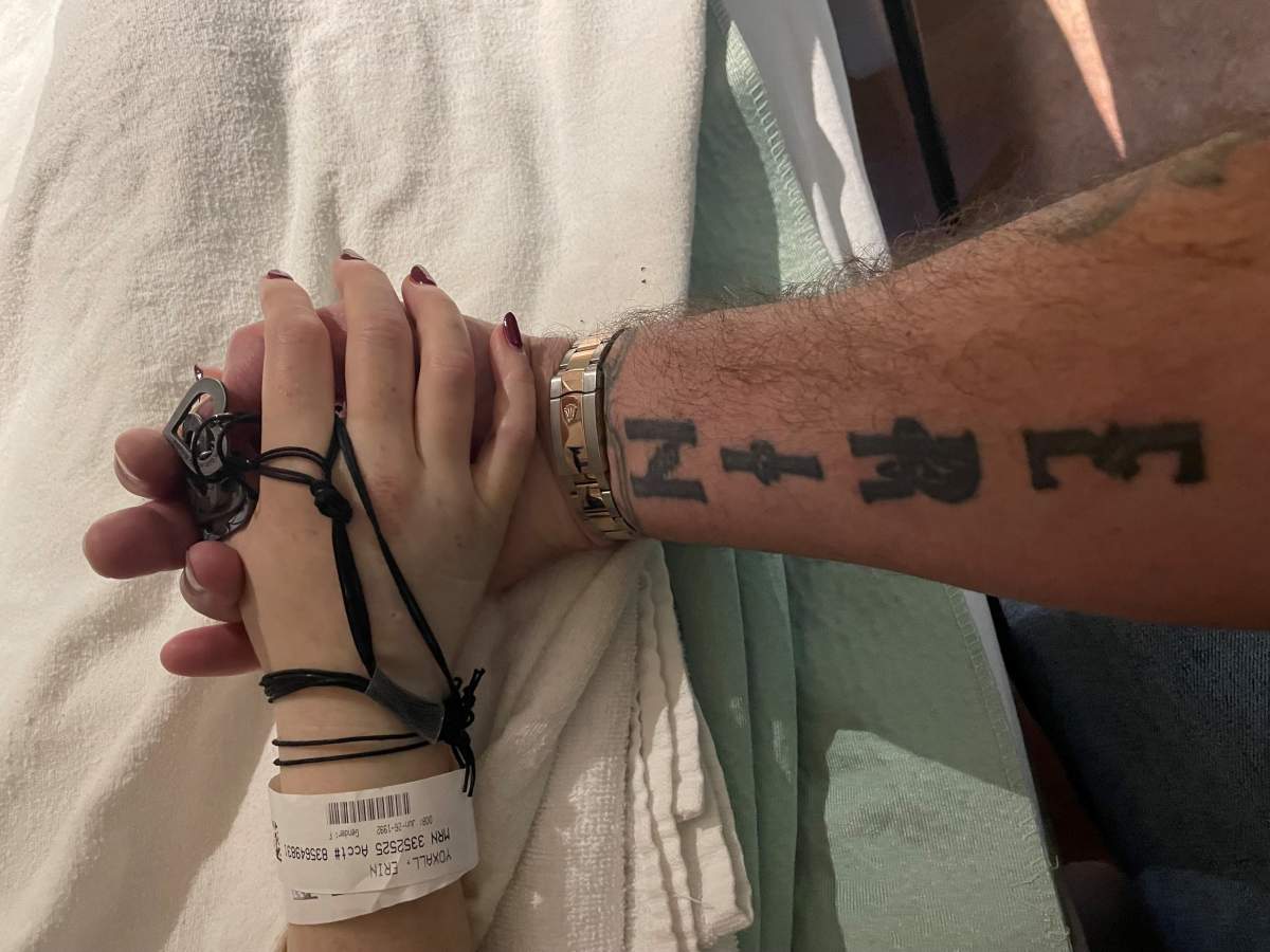 Anthony Yoxall holds his daughter Erin Yoxall’s hand in hospital after she was struck by a vehicle in Toronto.