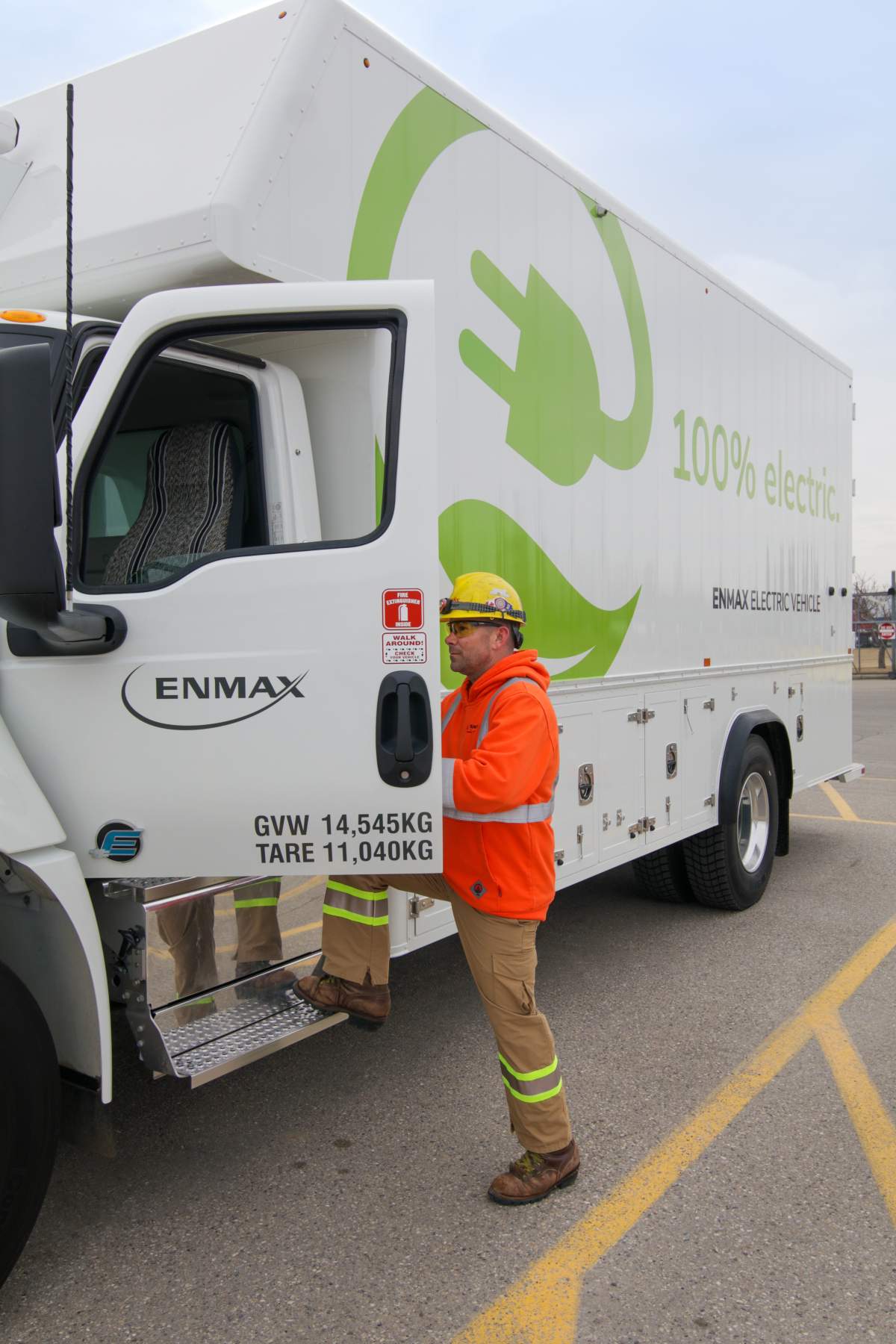 An Enmax worker enters one of the Calgary utility's two medium duty electric vehicles, on April 11, 2022.