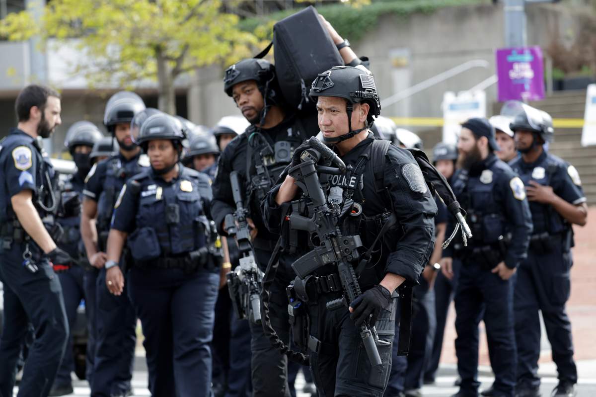 Metropolitan Police stage in the middle of Connecticut Avenue Northwest as they arrive on the scene of a shooting on April 22, 2022 in Washington, DC. Police evacuated residents from the shooting scene Friday afternoon and there were reports of several shooting victims.