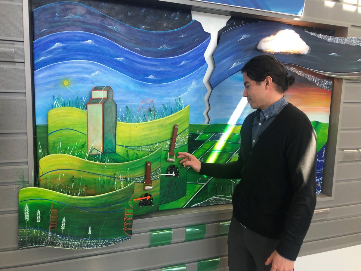 Bruno Hernani interacts with his new artwork at the city of Regina's Waste Management Centre.