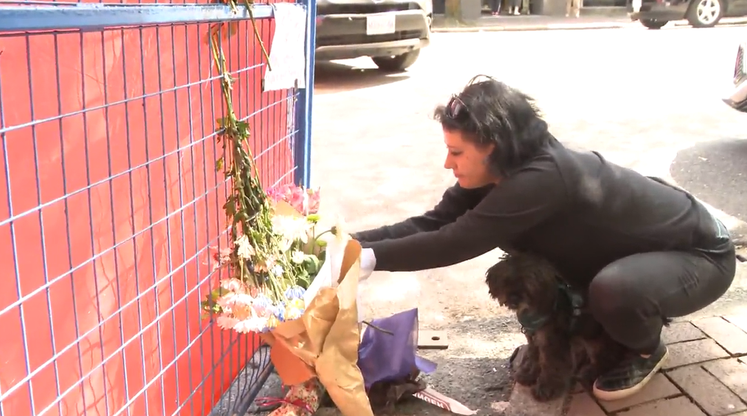 Candice Mclaurin lays flowers at a memorial for victims of the Winters Hotel fire.