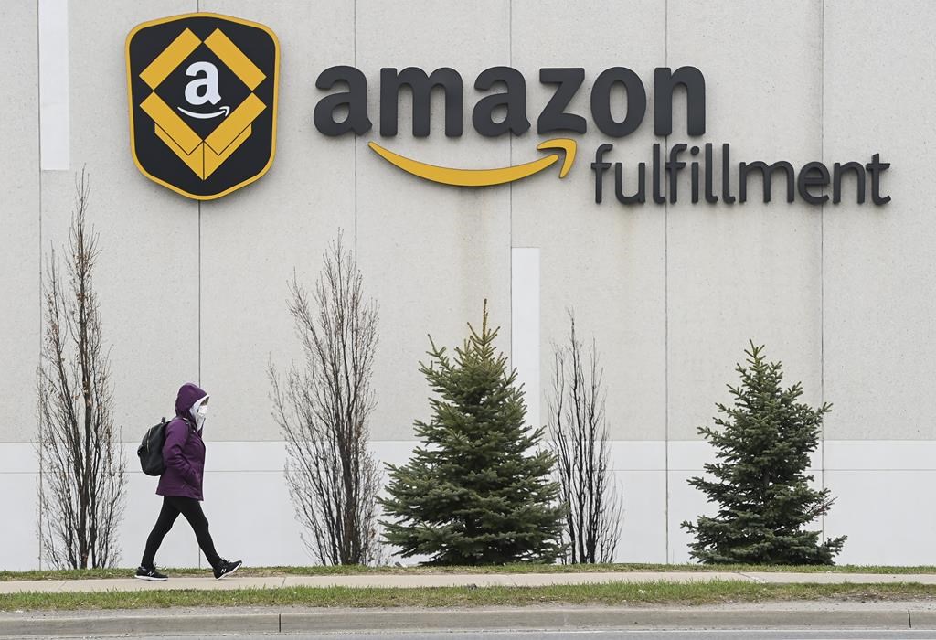 A person walks past an Amazon Fulfillment Centre during the COVID-19 pandemic in Brampton, Ont., Tuesday, April 20, 2021.THE CANADIAN PRESS/Nathan Denette.