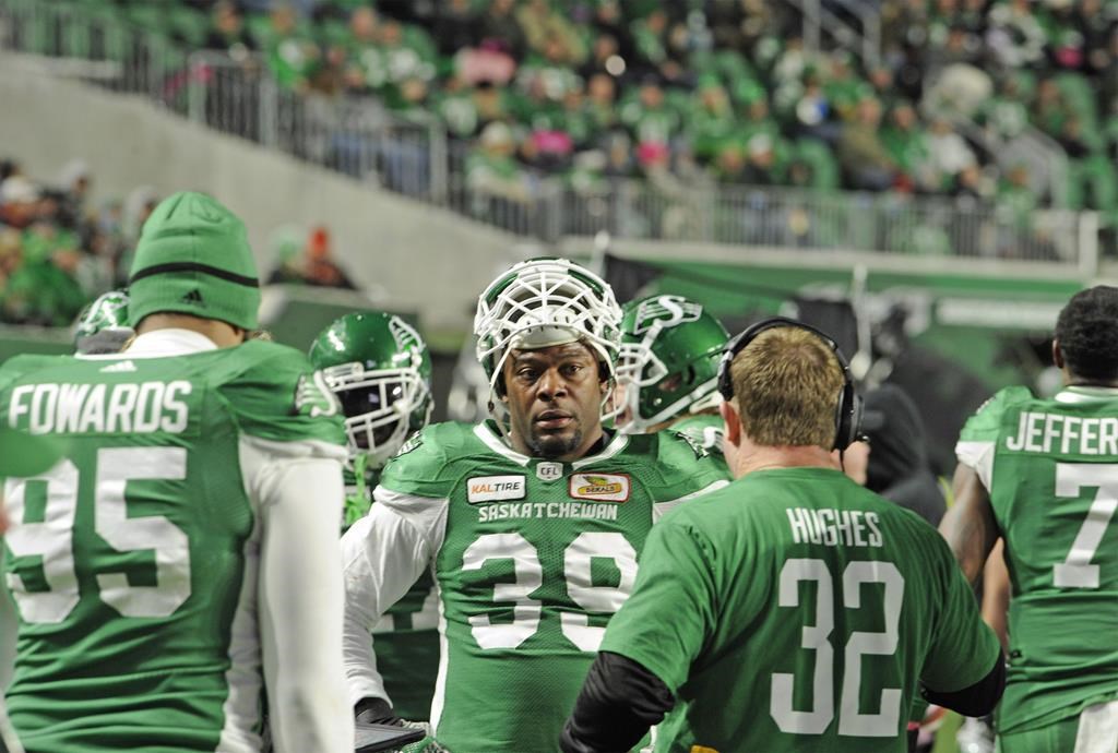 Saskatchewan Roughriders defensive lineman Charleston Hughes talks with head coach Chris Jones on the sidelines during second half CFL action against the B.C. Lions at Mosaic Stadium in Regina on Saturday, Oct. 27, 2018. THE CANADIAN PRESS/Mark Taylor.