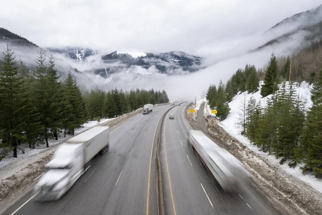 FILE. Vehicles are seen as they drive along the Coquihalla Highway Wednesday, Jan. 19, 2022. Highways through southern British Columbia's mountain passes are expected to get snow this week.