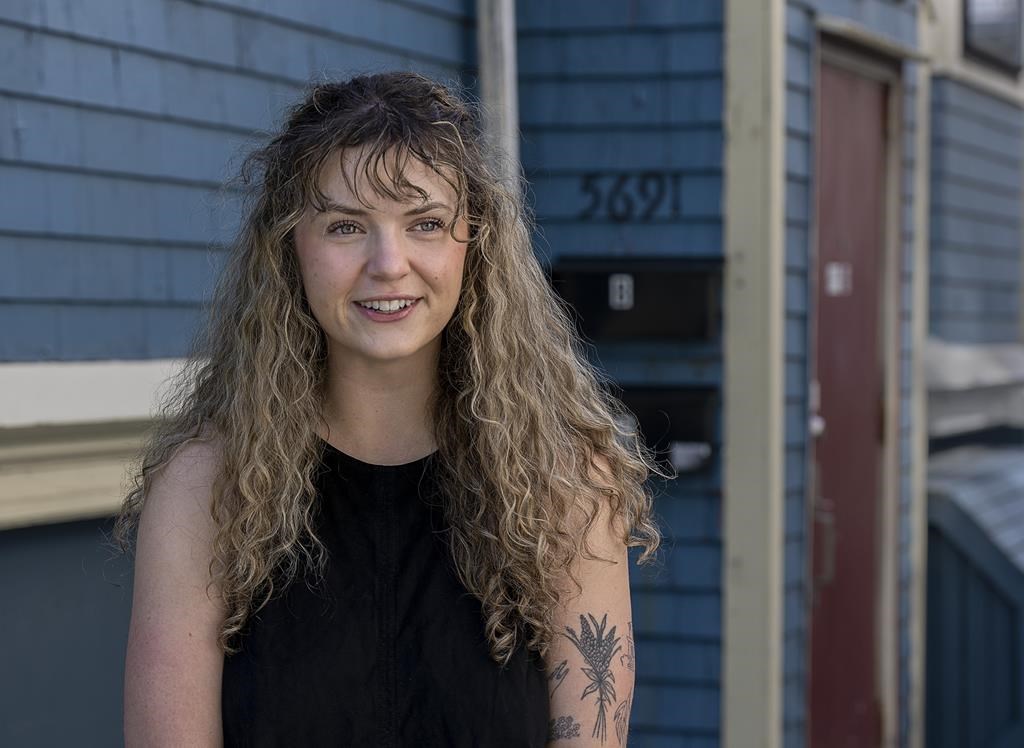 Gina Grattan stands near her apartment in Halifax on Tuesday, May 24, 2022. Grattan is part of a growing cohort of young people struggling with the affordability of living in the city as rental costs soar. THE CANADIAN PRESS/Andrew Vaughan.
