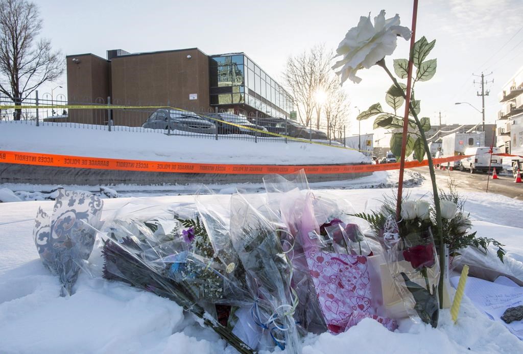 Flowers are seen near a mosque where a shooting left six people dead and eight others injured on Jan. 30, 2017 in Quebec City. 
