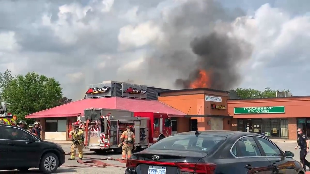 London fire crews stationed outside the Pizza Hut at Highbury Avenue and Huron Street in London, Ont., May 31, 2022.