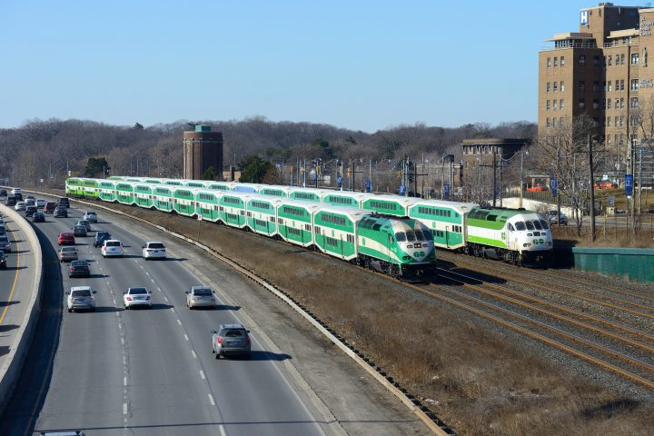 A pair of GO Trains travelling beside the Gardiner Expressway in Toronto, Ont., February 18, 2018. 