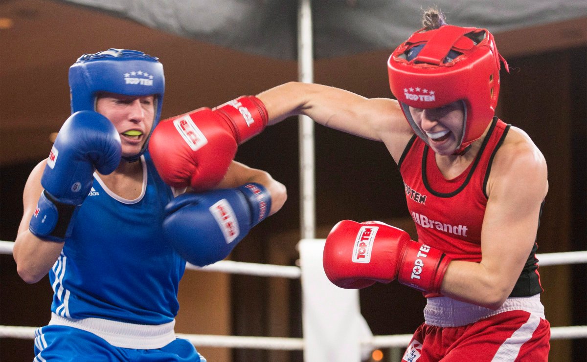 Mandy Bujold, right, of Ontario, lands a blow to the head of Kim Klavel, of Quebec, during their 51kg bout at the Canadian Olympic boxing trials, in Montreal, on Wednesday, Dec. 9, 2015. THE CANADIAN PRESS/Graham Hughes.