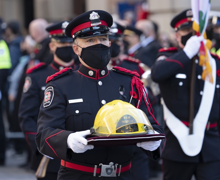 The helmet of fireman Pierre Lacroix is carried to the church for his funeral services in Montreal, Friday, Oct. 29, 2021. Lacroix drowned during a rescue operation in the Lachine Rapids Oct. 17, 2021.
