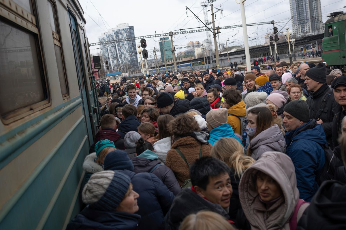 People, mostly women and children, try to get onto a train bound for Lviv, at the Kyiv railway station, Ukraine, Friday, March 4, 2022.  